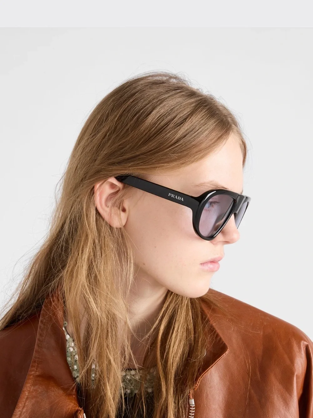 Prada Black Frame Sunglasses with Purple-Tinted Lenses